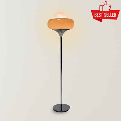 Adeline Floor Lamp with a glossy orange hand-crafted glass shade, slim black metal stand, and warm glowing dome detail, designed as a Bauhaus-inspired statement lamp for living rooms, bedrooms, and reading corners.