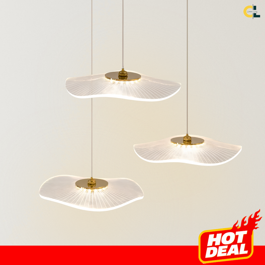 Daffodil chandelier with translucent petal-shaped acrylic shades and gold-tone fittings, suspended at staggered heights and glowing with soft warm LED light against a neutral background.