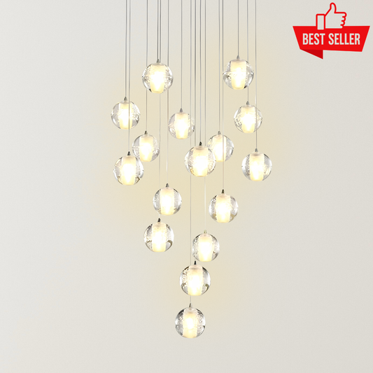 Elizabeth Mystic Globes chandelier with cascading clear crystal globe pendants, warm glowing lights, and slim suspension wires creating a luxurious staircase statement design.