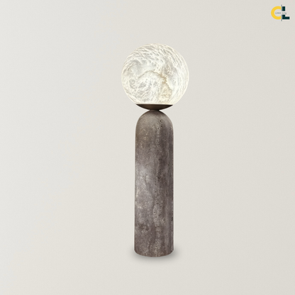 Lionel Alabaster Lamp with a glowing Spanish alabaster globe, natural stone texture, and tall rounded travertine base, designed as a sculptural accent lamp for bedrooms, living rooms, and reading corners.