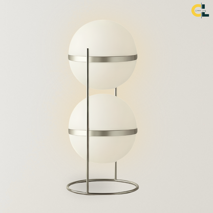 Magnus Floor Lamp with two stacked frosted acrylic globe shades, slim stainless steel frame, and circular base, designed for soft modern lighting in bedrooms, living rooms, offices, and reading corners.
