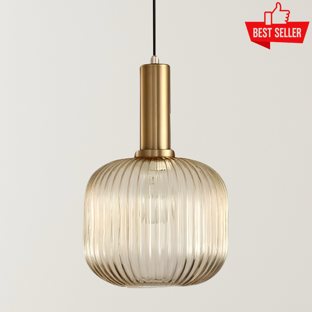 Mira Fluted Pendant Light with a ribbed amber glass shade, brushed gold metal frame, black cord, and warm glow for cafés, restaurants, and modern interiors.