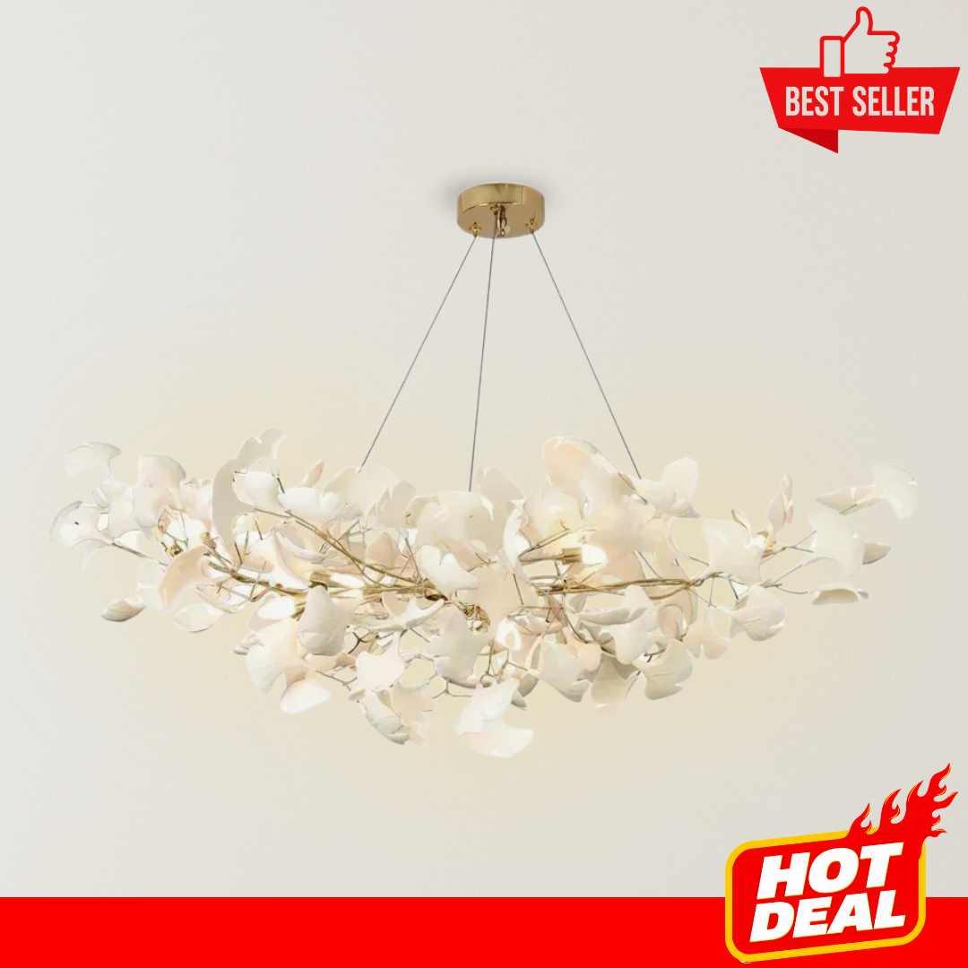 Nayomi Nordic Ceramic Ginkgo Leaf Chandelier with white ceramic leaf accents, a delicate gold-toned branch frame, and warm ambient lighting suspended by slim wires against a neutral background.